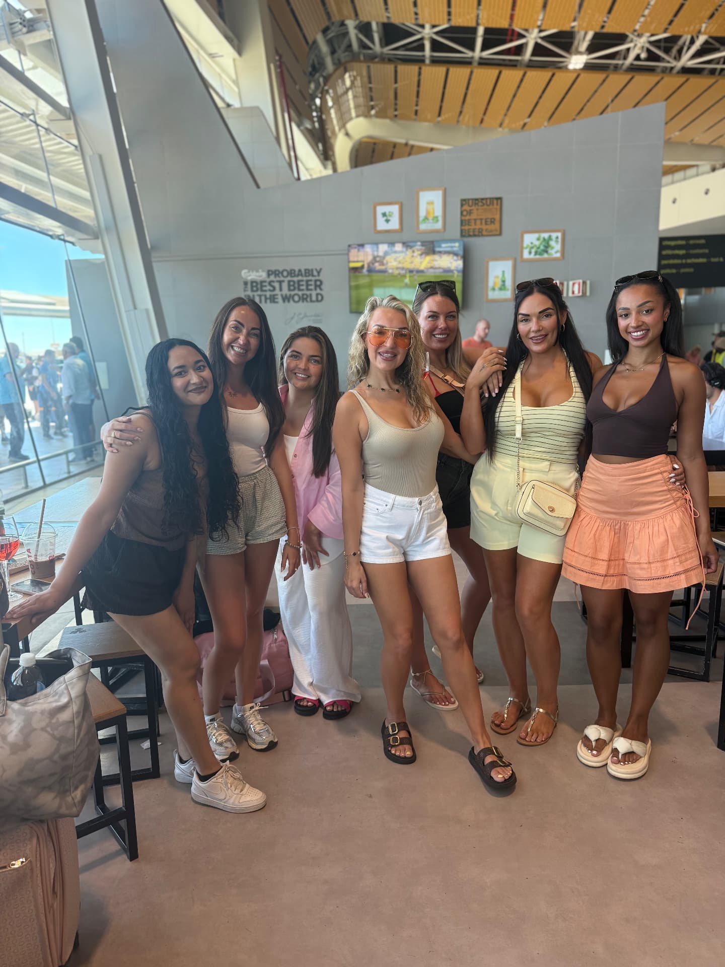A group of She Goes Solo girls smiling together at the airport